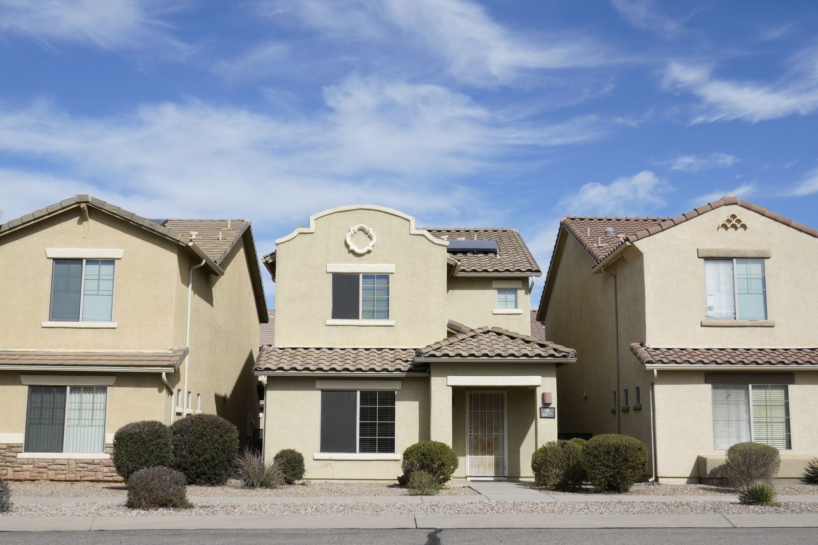 Row of stucco and tile-roof houses in a Tucson, Arizona suburban neighbourhood
